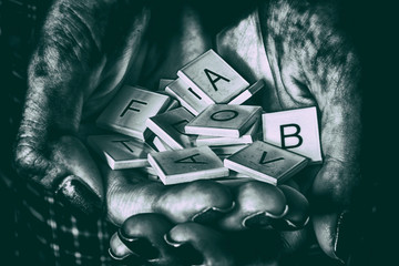 Fototapeta premium hands holding random alphabet letters - b&n hdr