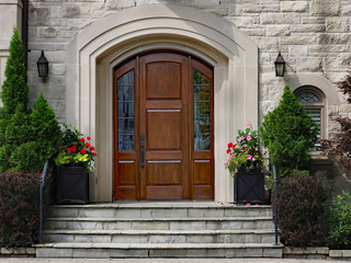 Fototapeta na wymiar elegant front door of stone house with flagstone steps