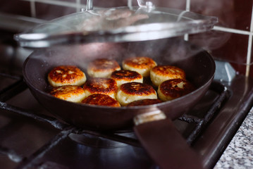 Frying pancake curd in a frying pan