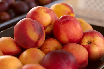 Red peaches. Background. Cropped snapshot. Image of fruit in a store or buffet. The concept of proper nutrition.