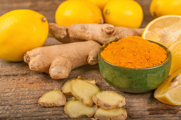 turmeric, lemon and ginger on a rustic surface, the concept of natural nutrition and medicine