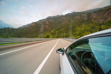 Fototapeta na wymiar Car in motion blur driving in the Mountains