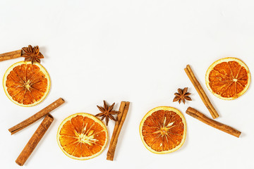 Dried oranges slices and cinnamon sticks on light background. Spices for hot wine.