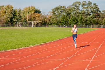 Fototapeta premium Healthy lifestyle young fitness woman running at outside