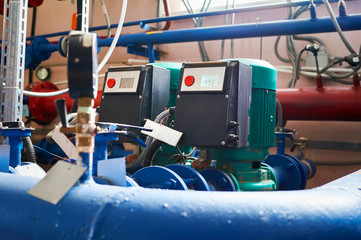 Blue engine with a pump and a frequency converter connected to the blue pipes.