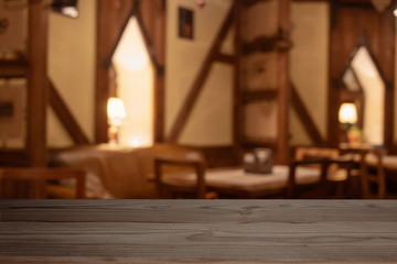 Fototapeta na wymiar Empty wooden table on the dark background of the room restaurant