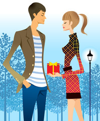 Woman giving man gift, trees in background