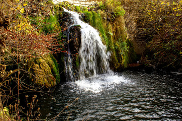 Small waterfall on Grza river in autumn. Beautiful small river surrounded with forest in nature park Grza.
