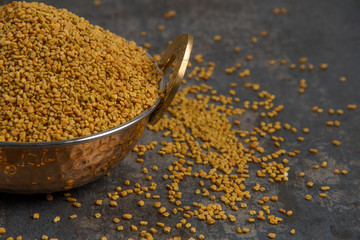 Fenugreek Seeds isolated on texture background.