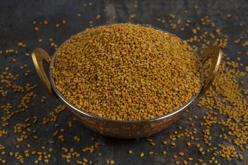 Fenugreek Seeds isolated on texture background.