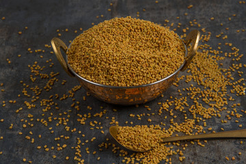 Fenugreek Seeds isolated on texture background.