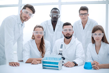 Group of scientists with gowns in laboratory