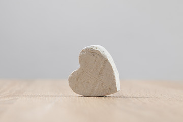 Wooden white heart on wooden table