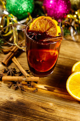 Christmas mulled wine with spices and Christmas decoration on wooden table