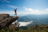 Young man standing on the edge of the rock