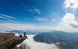 Young man sitting at the edge of the cliff