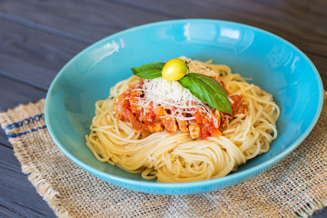 Delicious spaghetti served on a blue plate 