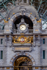 Fototapeta premium Clock at the upper level of the Central Station in Antwerp. The original building was designed by Clement Van Bogaert and was constructed between 1895 and 1905.