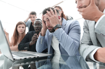 businessmens looking stressed in front of a laptop