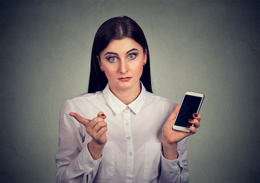 Annoyed woman upset with smartphone