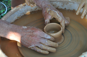 Potter teaches modeling pots and vases of clay on the Potter's wheel