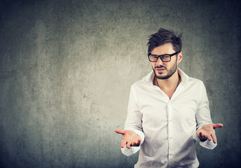 Irritated man in misunderstanding looking at camera