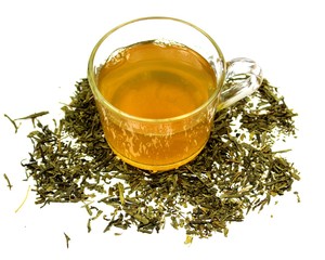 Fototapeta premium cup of green tea with tea leaves around isolated on white background