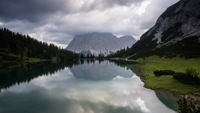 Time lapse reflection of clouds and mountain Zugspitze in lake Seebensee Bavaria Germany Alps Ehrwald Tirol travel hiking wanderlust landscape