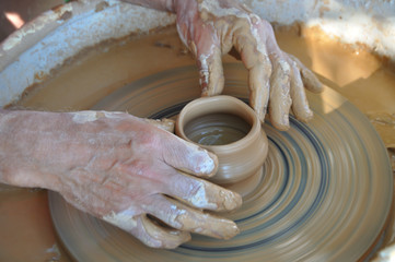 Potter teaches modeling pots and vases of clay on the Potter's wheel