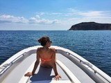 Rear view of woman relaxing on boat