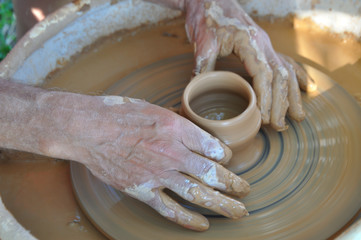 Potter teaches modeling pots and vases of clay on the Potter's wheel