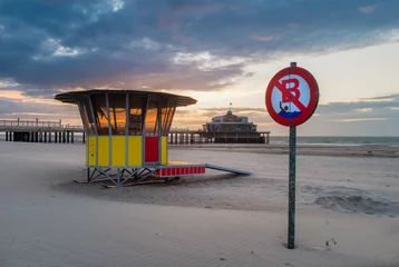 Poster Old wooden pier of Blankenberge at low tide © Erik_AJV