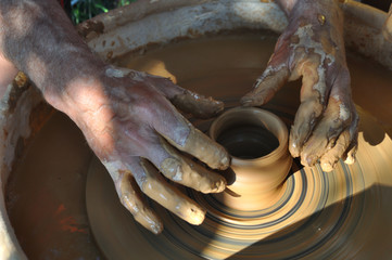 Potter teaches modeling pots and vases of clay on the Potter's wheel