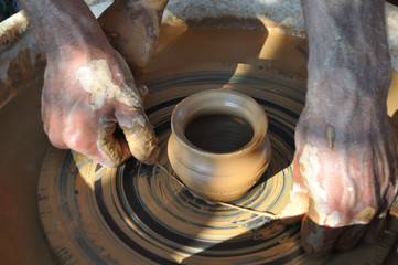 Potter teaches modeling pots and vases of clay on the Potter's wheel