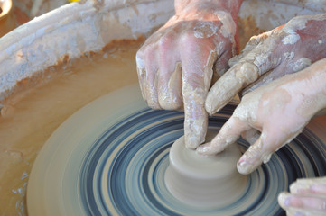 Potter teaches modeling pots and vases of clay on the Potter's wheel