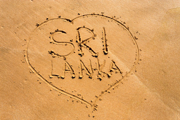 Sri Lanka written on sand. Tropical holiday concept