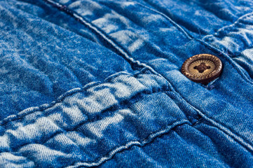 Blue washed faded jeans texture with seams, clasps, buttons and rivets
