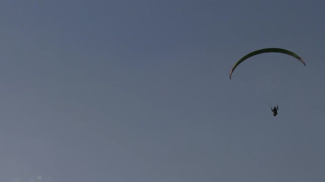 Flying paragliders.