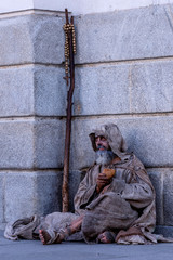 Ragged beggar begging on the street