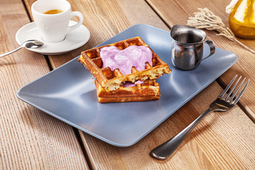 Fototapeta na wymiar Close up view of Belgian waffles with ice cream and coffee. Sweet breakfast concept. Copy space for text, brand or logo. Photo for recipe