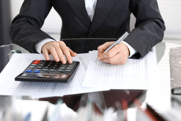 Bookkeeper woman or financial inspector  making report, calculating or checking balance, close-up. Business portrait. Copy space area for audit or tax concepts