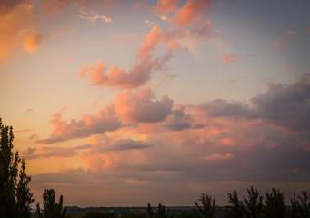 Landscape with dramatic light - beautiful golden sunset with saturated sky and clouds.