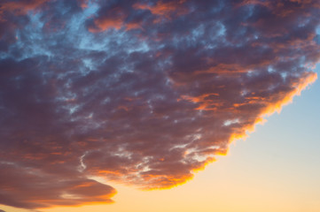 Landscape with dramatic light - beautiful golden sunset with saturated sky and clouds.