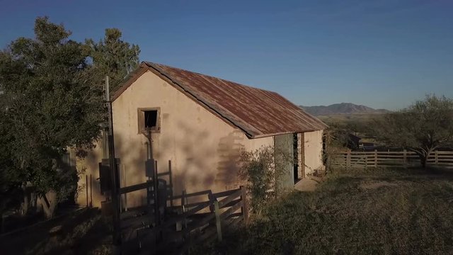Aerial lift over an old adobe barn on a southwest ranch
