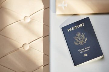 Passport of United States of American. Traveling passport.  closeup of an american passport and laptop on a couch for a travel concept.