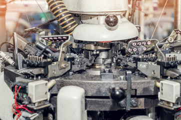 Details of knitting machines in the factory, springs, threads, guide elements