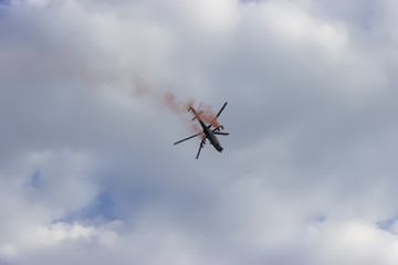 Combat helicopter with red smoke