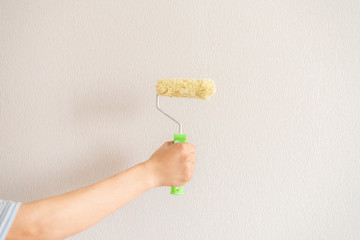 roller painting wall at home f