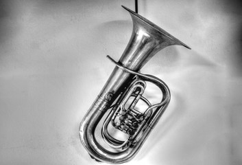 an old trombone hanging from a wall
