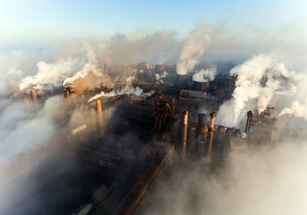 Fototapeta na wymiar Industrial city of Mariupol, Ukraine, in the smoke of industrial plants and fog at dawn.